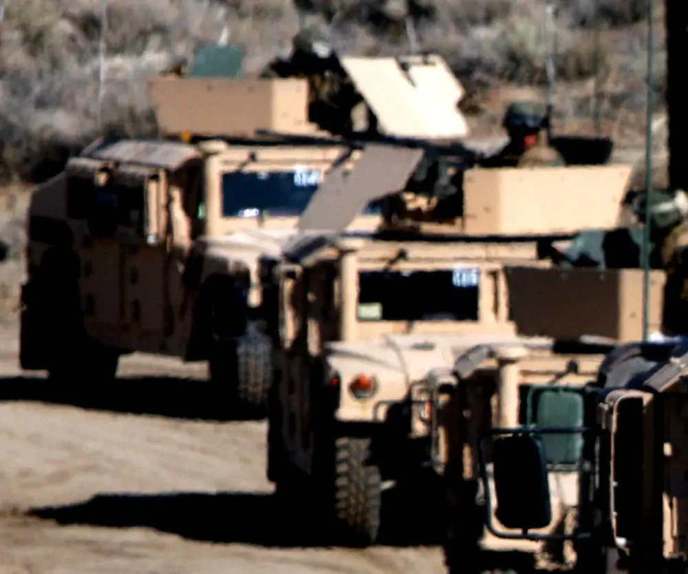 HMMWV vehicles traveling in convoy